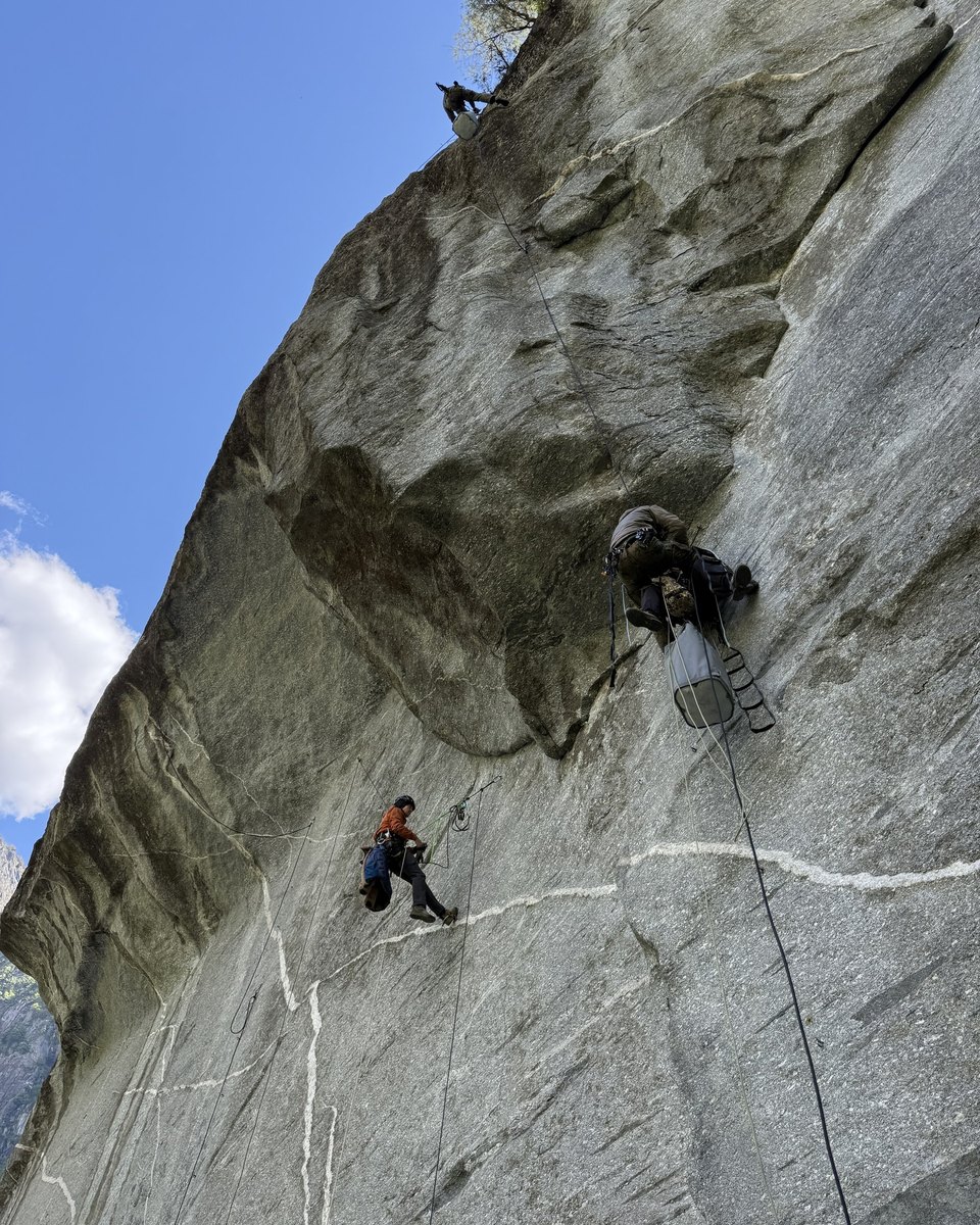 Kletterer in einer steilen Granitwand unter einem Felsdach